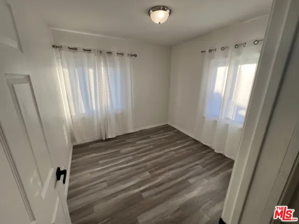 a view of a room with wooden floor