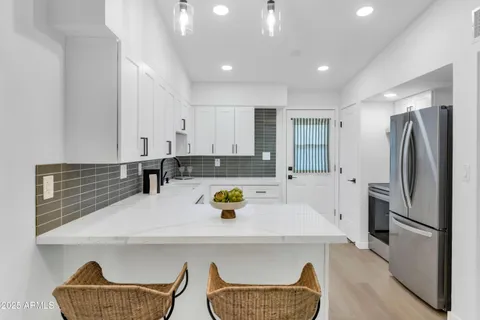 a kitchen with a refrigerator and a sink