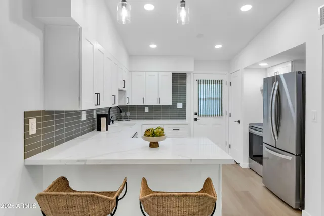 a kitchen with a refrigerator and a sink