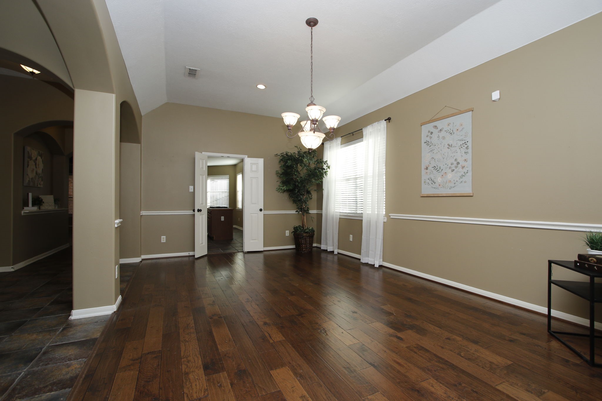 9203 Memorial Pines Way Spring, TX 77379 - Photo 11 of 45 This spacious room features an elegant chandelier and classic wainscoting, making it ideal for a dining and living area.