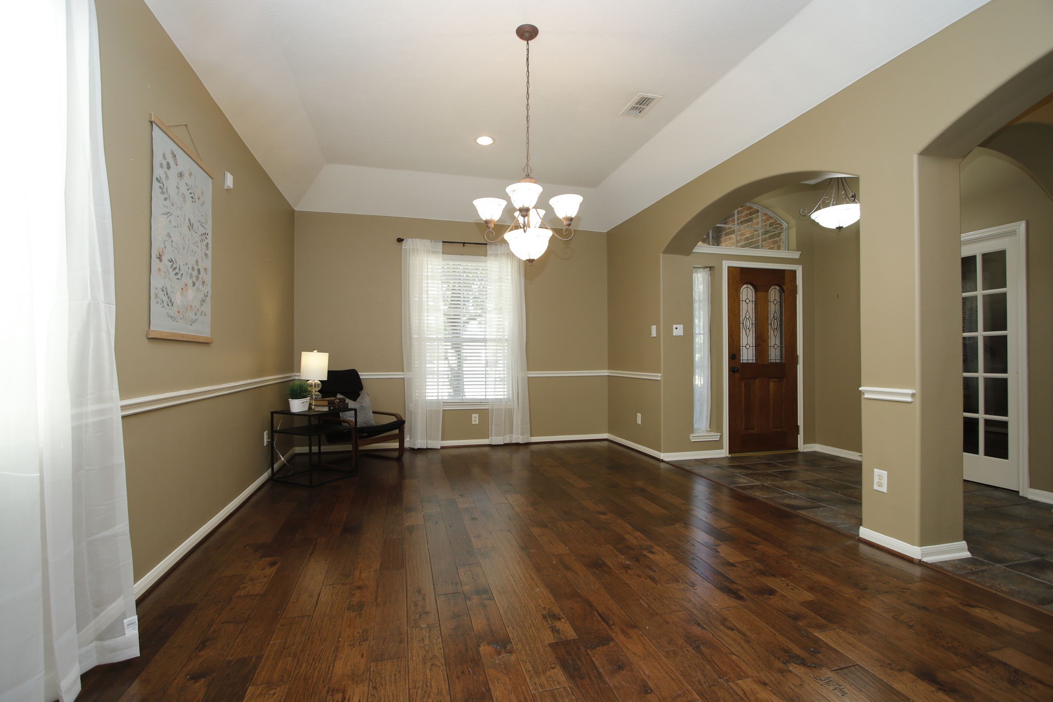 9203 Memorial Pines Way Spring, TX 77379 - Photo 12 of 45 This inviting formal living and dining room features rich hardwood floors and warm beige walls with white trim.