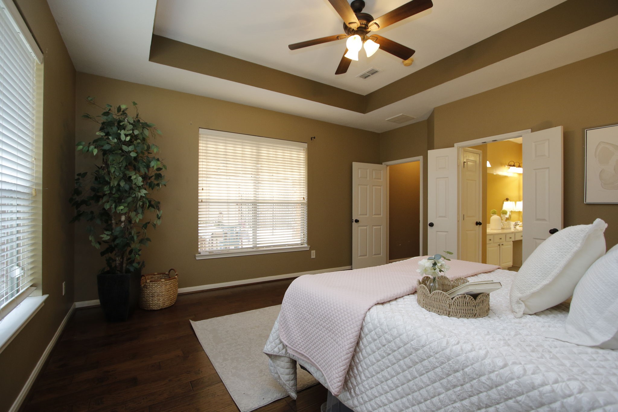 9203 Memorial Pines Way Spring, TX 77379 - Photo 22 of 45 This spacious primary bedroom has a large window for natural light, a ceiling fan, and access to an en-suite bathroom.