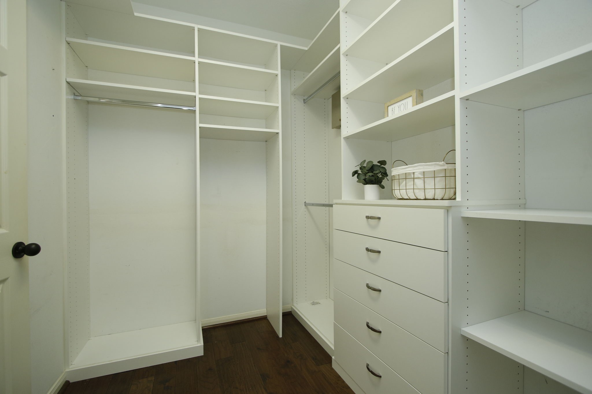 9203 Memorial Pines Way Spring, TX 77379 - Photo 24 of 45 This is another view of the great primary bedroom closet with white built-in shelves, drawers, and hanging racks, with dark hardwood flooring.