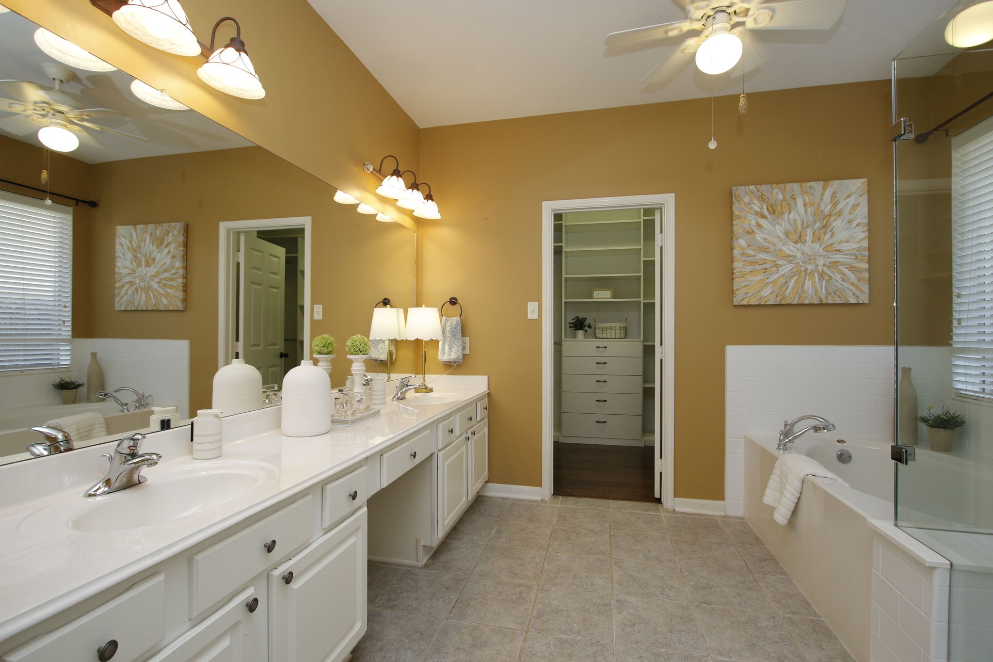9203 Memorial Pines Way Spring, TX 77379 - Photo 26 of 45 Spacious primary bathroom with dual sinks, a large mirror, and ceiling fan features a soaking tub, walk-in closet, and neutral decor for a relaxing atmosphere.
