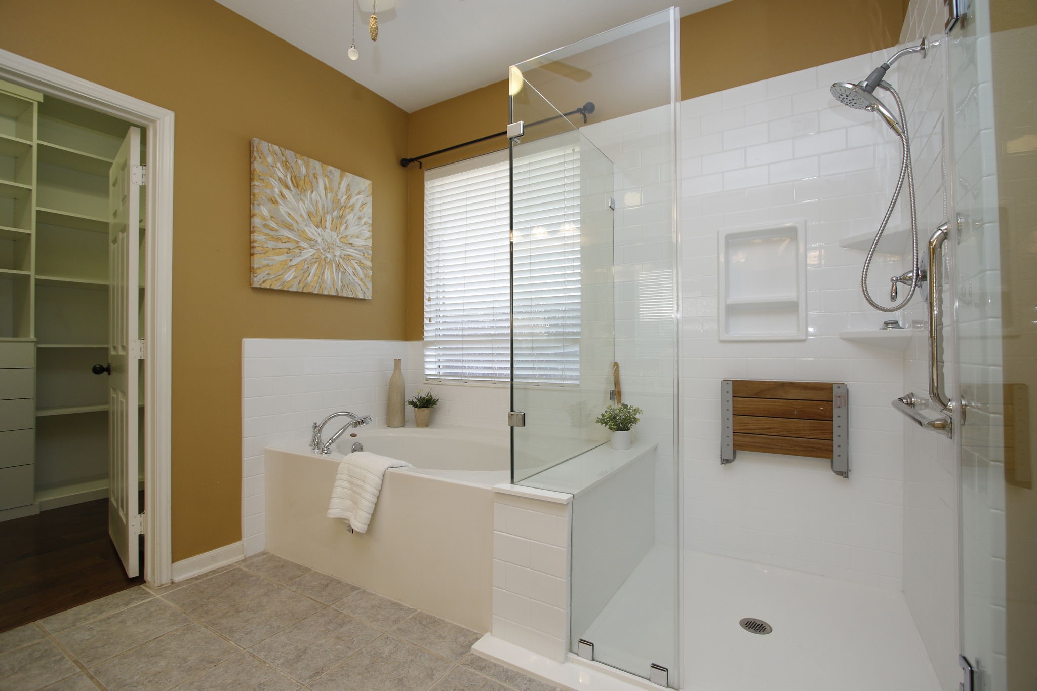 9203 Memorial Pines Way Spring, TX 77379 - Photo 27 of 45 The primary bathroom features a spacious, modern design with a glass-enclosed shower with fold down teak seat and a separate bathtub.