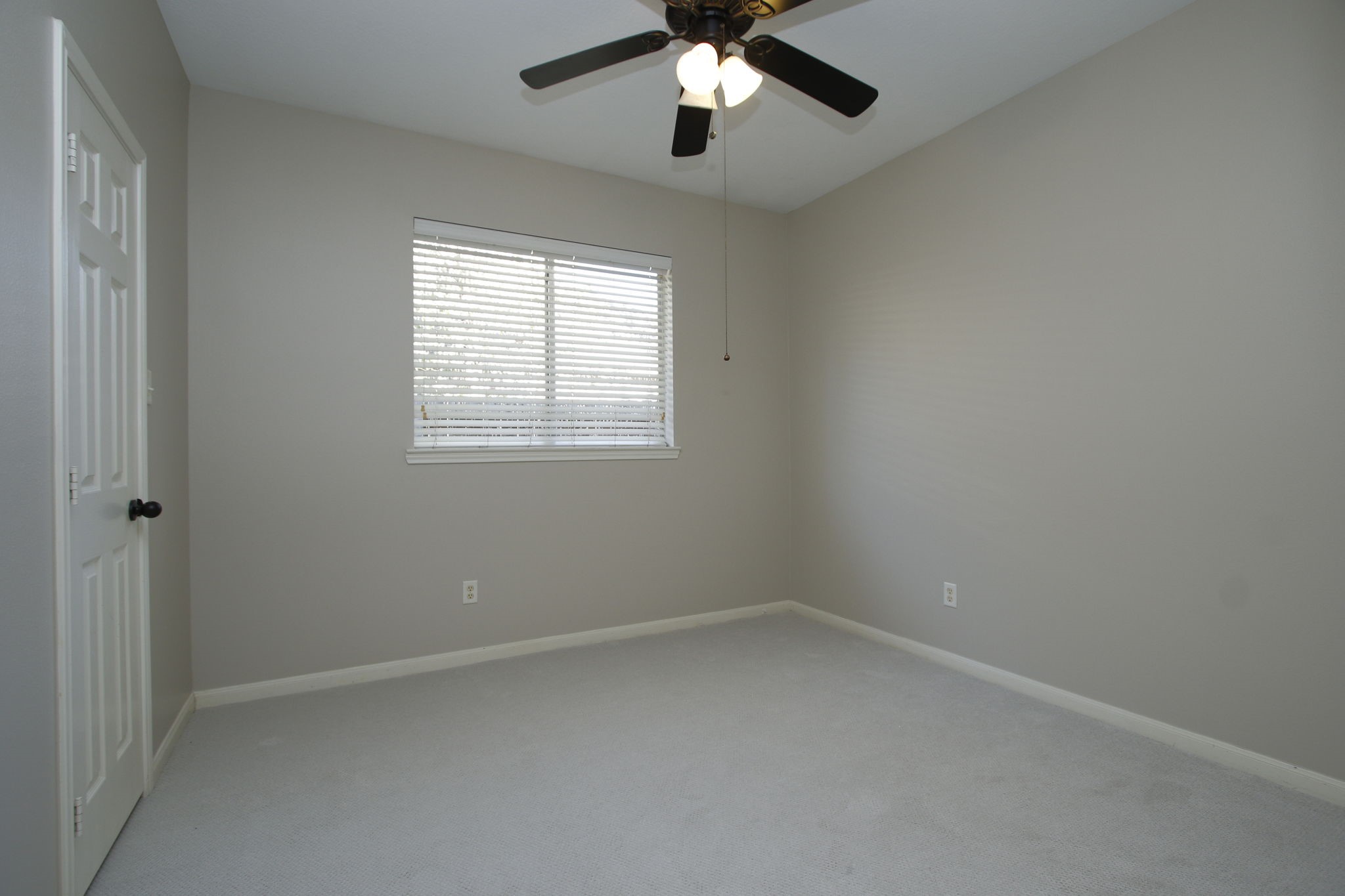 9203 Memorial Pines Way Spring, TX 77379 - Photo 28 of 45 This is one of the secondary bedrooms featuring a ceiling fan, a window with blinds, and new carpet.