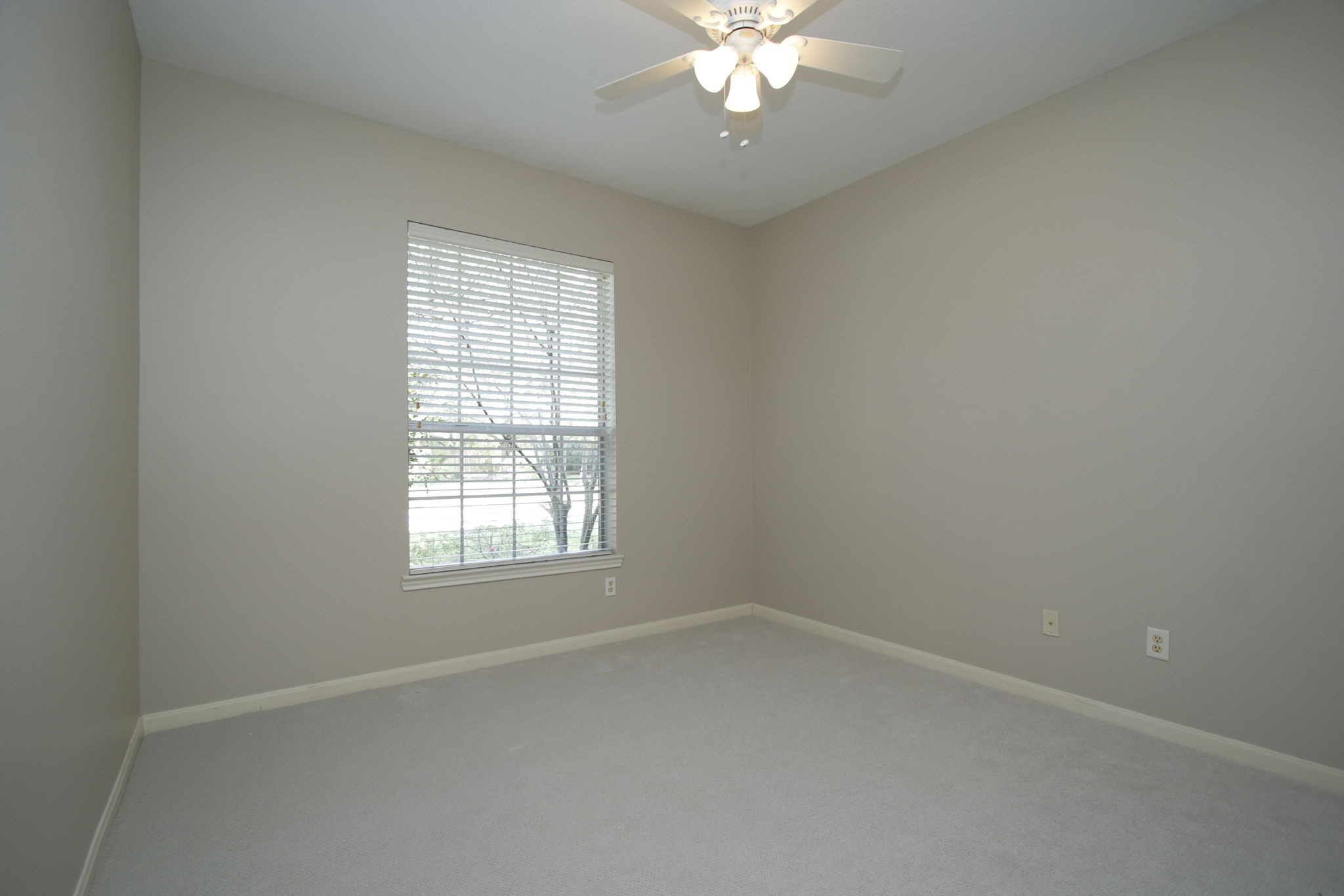 9203 Memorial Pines Way Spring, TX 77379 - Photo 30 of 45 This is the other secondary bed room at the front of the home featuring neutral walls and new carpet, and ceiling fan.