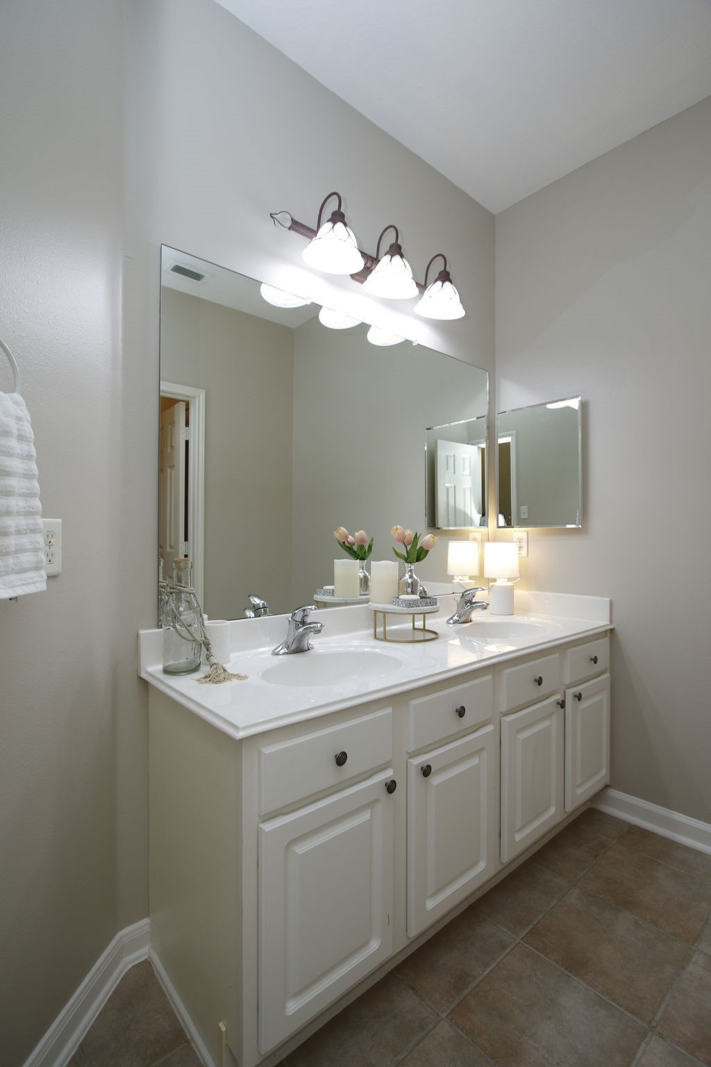 9203 Memorial Pines Way Spring, TX 77379 - Photo 32 of 45 This is the second bathroom that features a double vanity with white cabinets and a large mirror. It has overhead lighting and a neutral color palette, creating a bright and inviting space.
