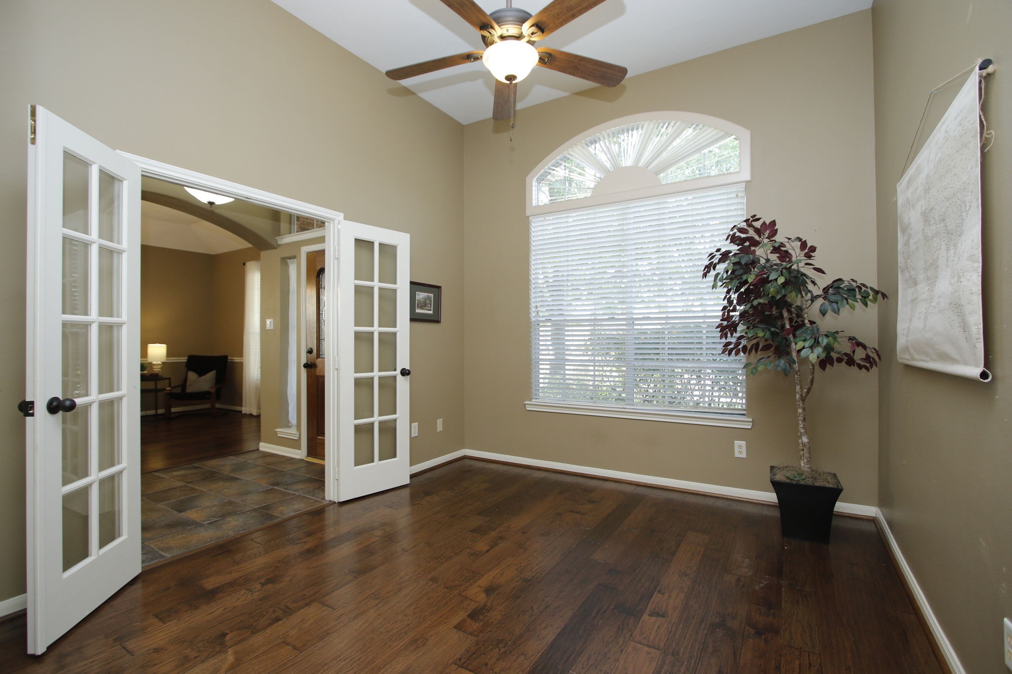 9203 Memorial Pines Way Spring, TX 77379 - Photo 33 of 45 This is the office which features hardwood flooring, a ceiling fan, and ample natural light from a large arched window. It includes elegant French doors leading to the foyer.