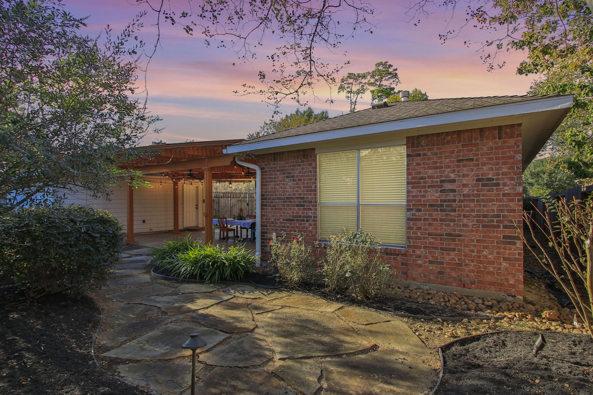 9203 Memorial Pines Way Spring, TX 77379 - Photo 40 of 45 The charming landscaped garden path behind the primary bedroom adds to the inviting, tranquil atmosphere.