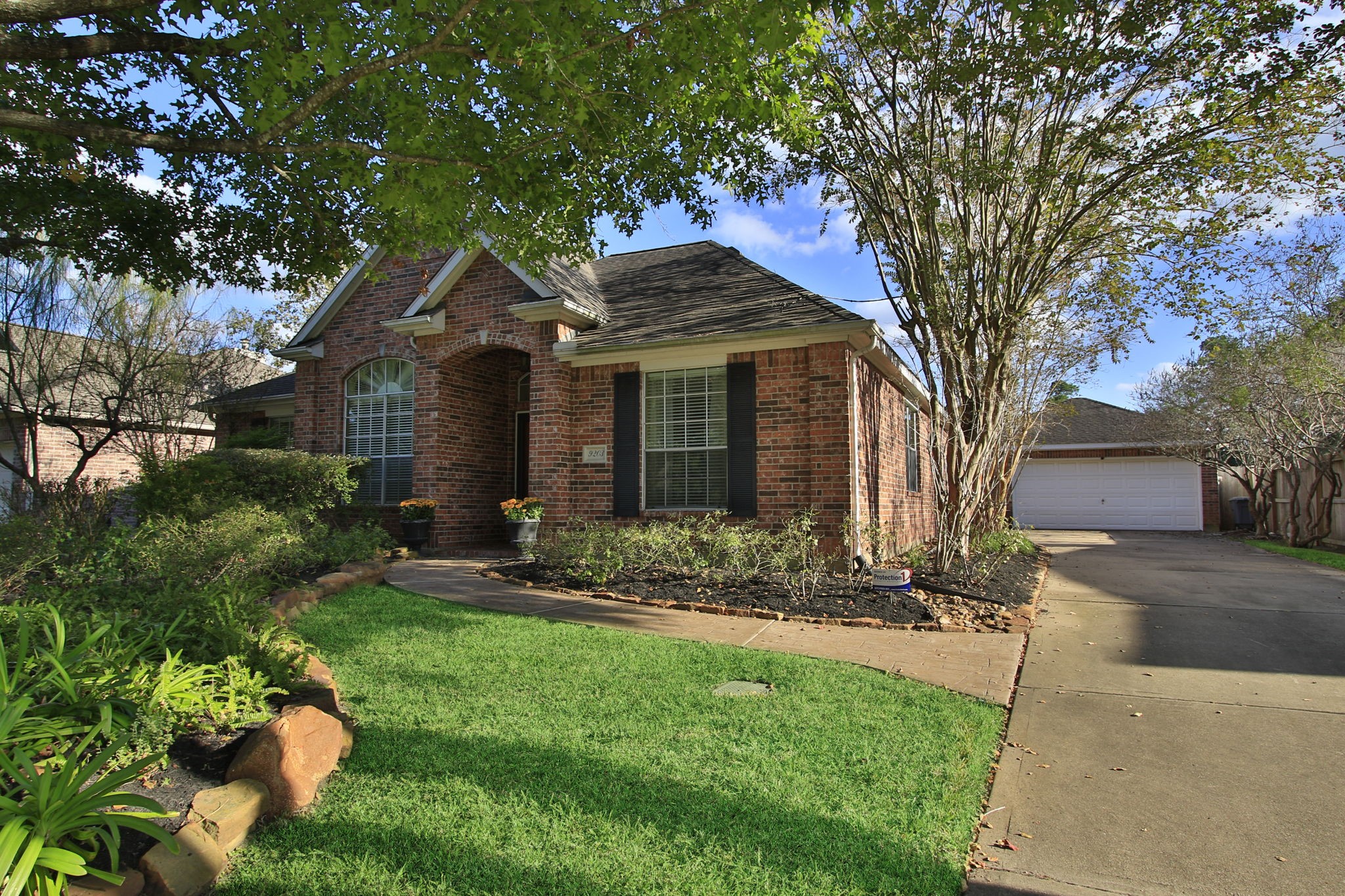 9203 Memorial Pines Way Spring, TX 77379 - Photo 4 of 45 The house has a welcoming front entrance with stamped concrete walkway.