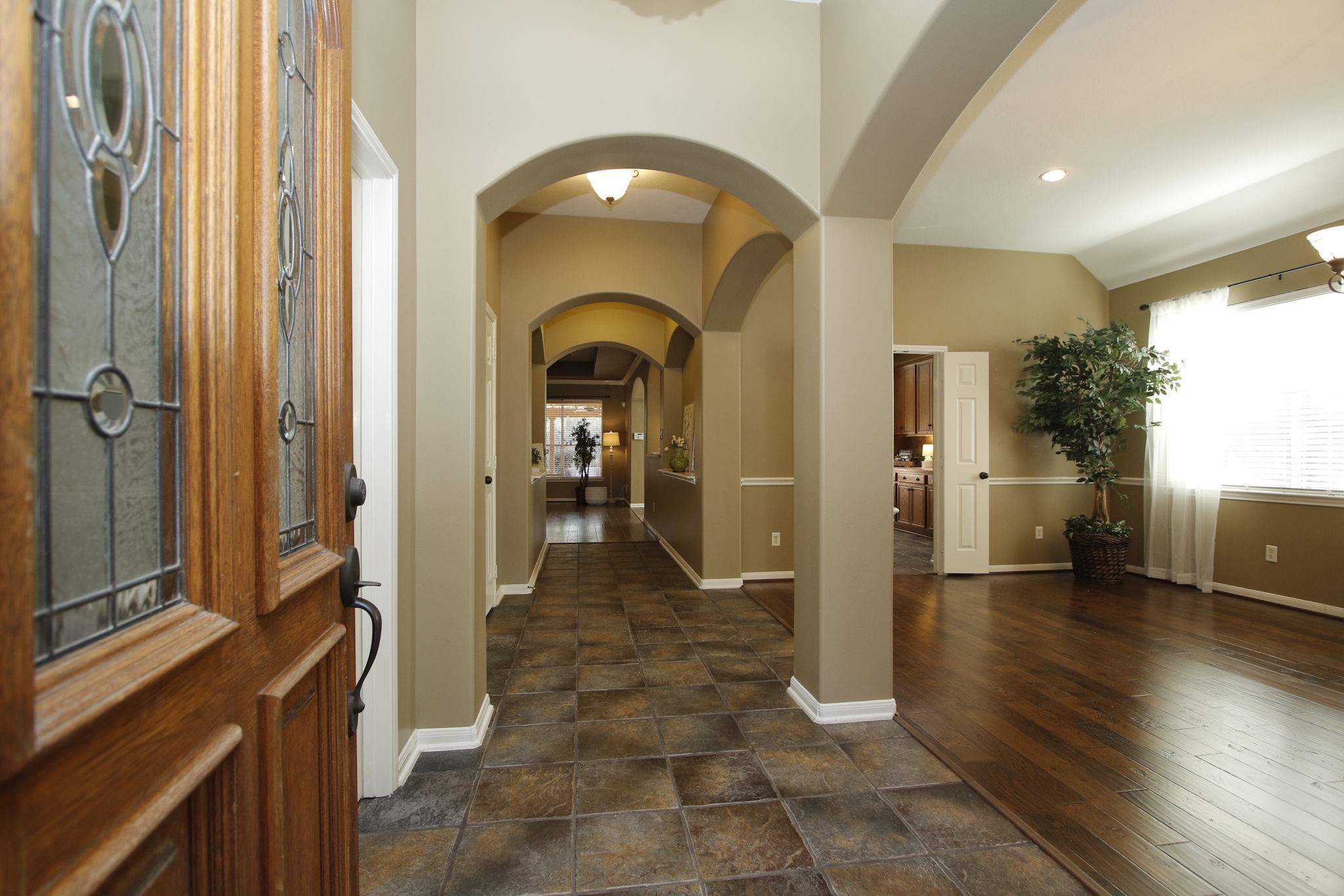 9203 Memorial Pines Way Spring, TX 77379 - Photo 8 of 45 The foyer has tiled flooring leading to an open living space with warm hand scraped hard wood floors, arched doorways, and ample natural light.