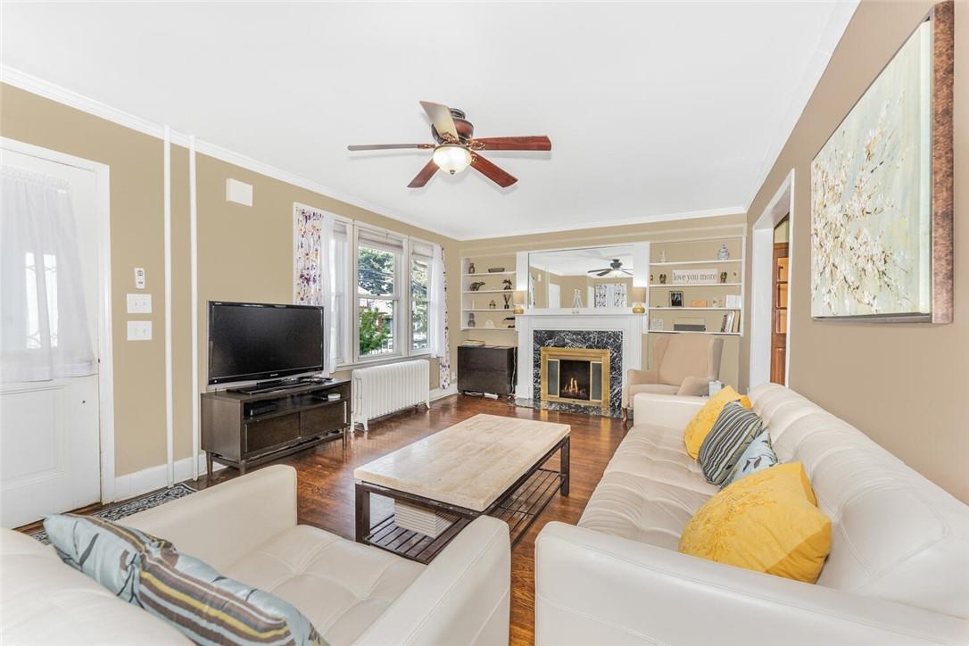 5650 Post Road Bronx, NY 10471 - Photo 11 of 34 a living room with furniture a flat screen tv and a fireplace
