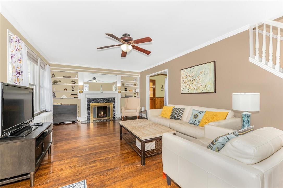 5650 Post Road Bronx, NY 10471 - Photo 12 of 34 a living room with furniture a fireplace and a flat screen tv