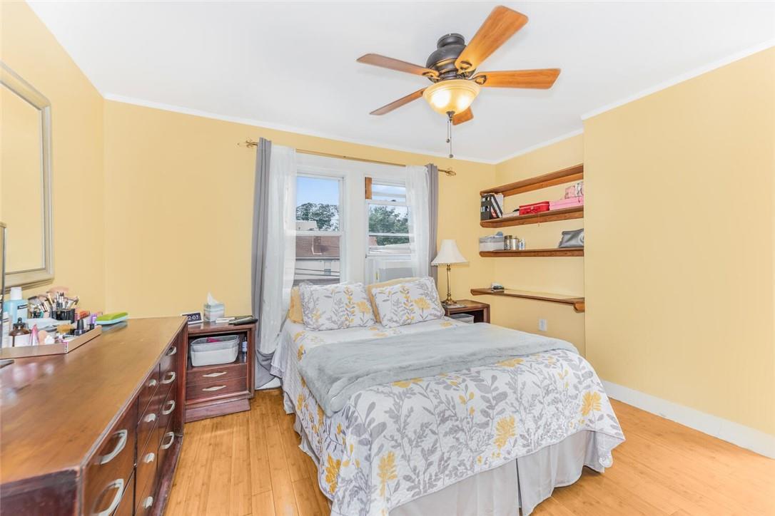 5650 Post Road Bronx, NY 10471 - Photo 17 of 34 a bedroom with a bed and a chandelier