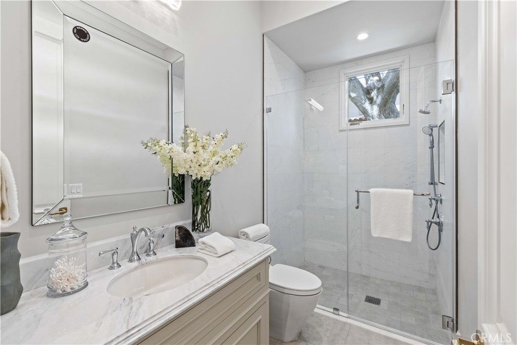 911 Hampton Road Arcadia, CA 91006 - Photo 20 of 73 a bathroom with a granite countertop sink a toilet and shower