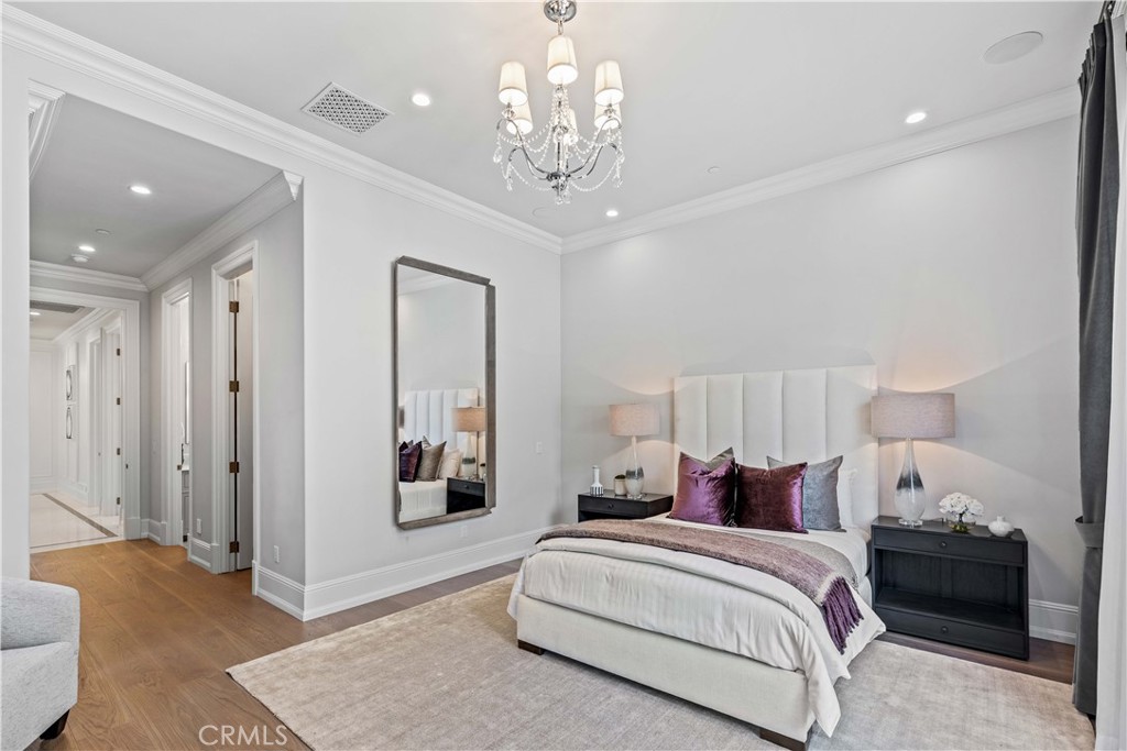911 Hampton Road Arcadia, CA 91006 - Photo 22 of 73 a spacious bedroom with a bed and a chandelier