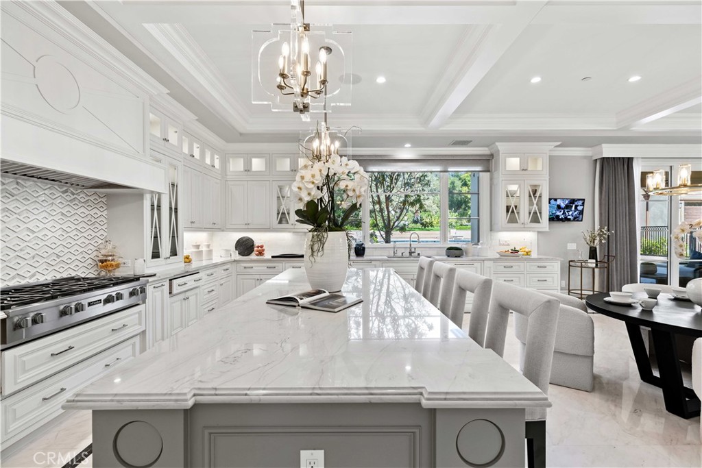 911 Hampton Road Arcadia, CA 91006 - Photo 28 of 73 a large kitchen with kitchen island a stove a sink a dining table and chairs