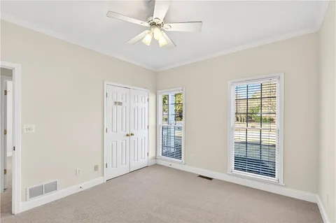 an empty room with fan and entrance