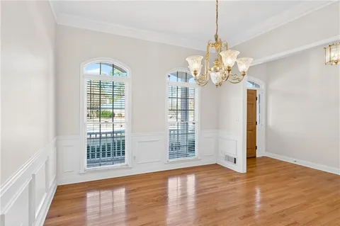 a view of a room with wooden flooring and chandelier