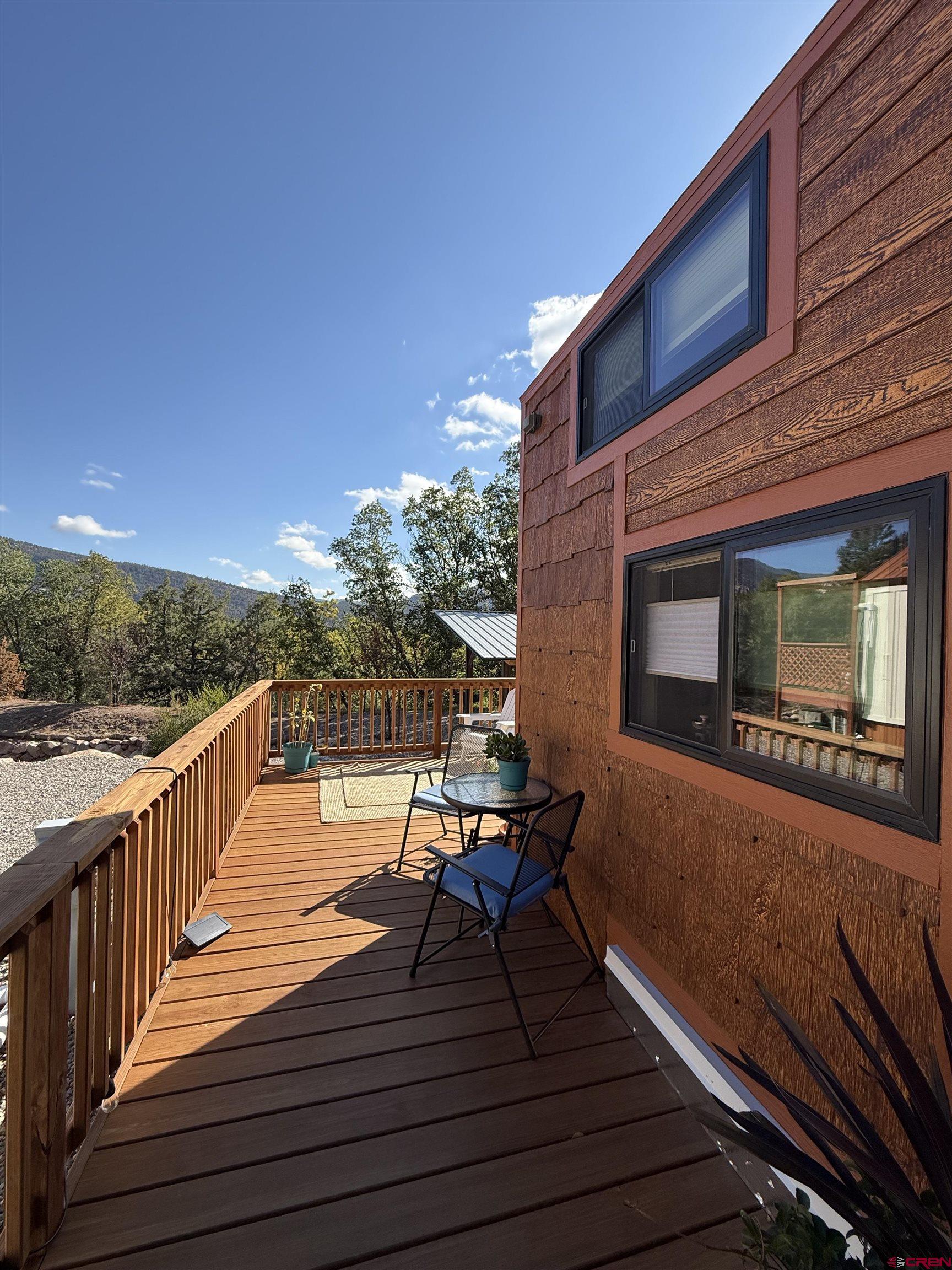 90 Animas View Drive, Unit 5 Durango, CO 81301 - Photo 17 of 30 a balcony with wooden floor and outdoor seating