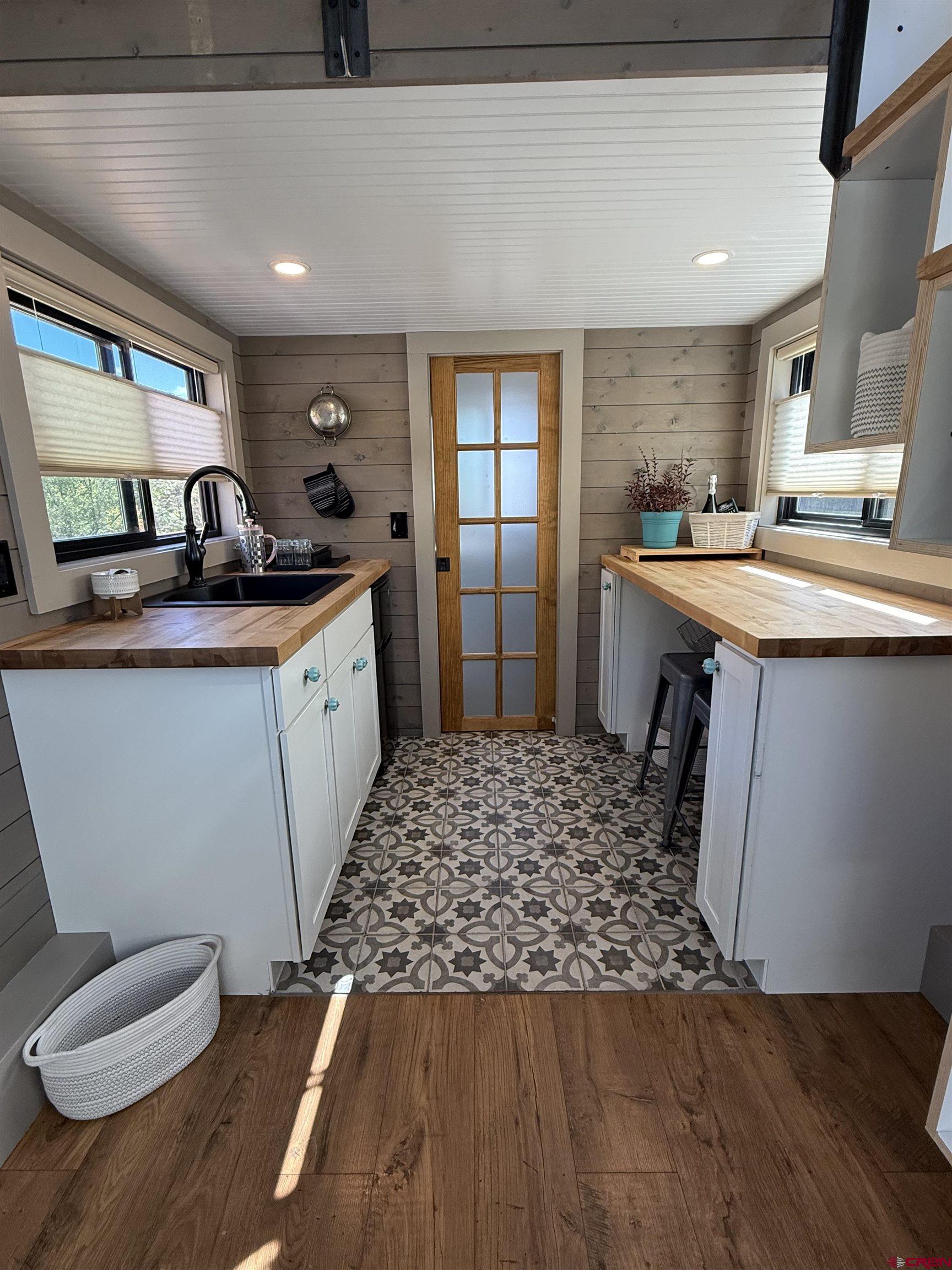 90 Animas View Drive, Unit 5 Durango, CO 81301 - Photo 26 of 30 a large kitchen with stainless steel appliances granite countertop a sink stove and wooden cabinets