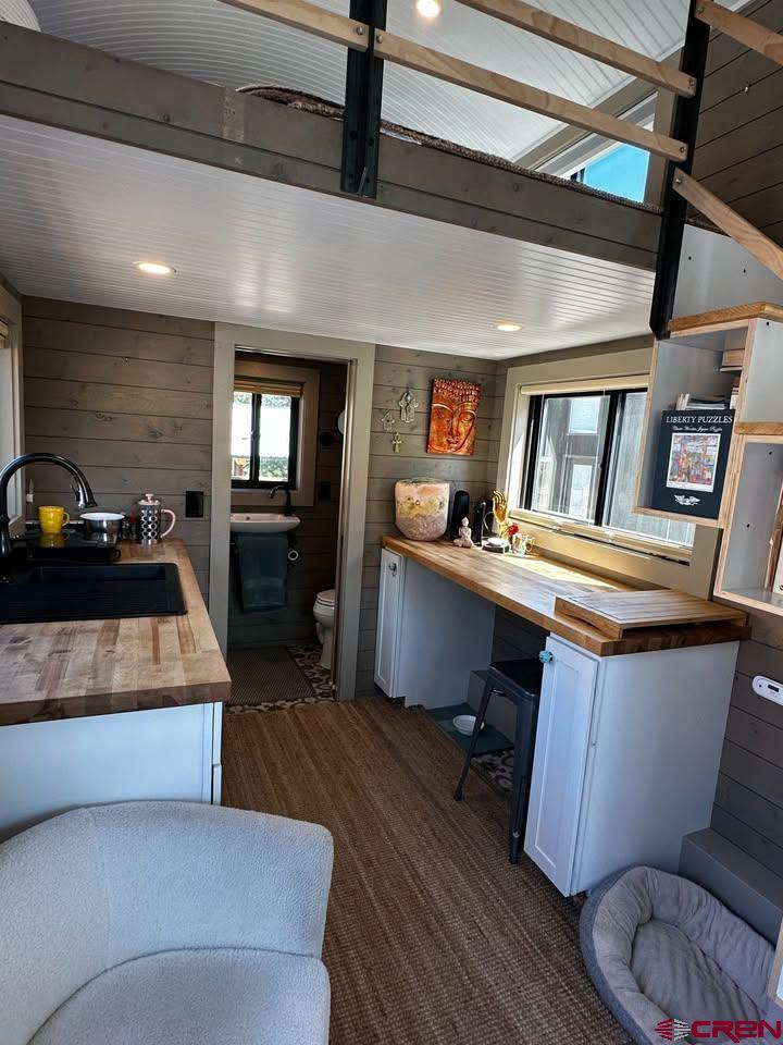 90 Animas View Drive, Unit 5 Durango, CO 81301 - Photo 4 of 30 a kitchen with a sink a counter and chairs