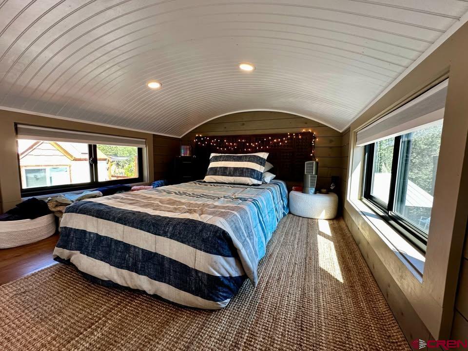 90 Animas View Drive, Unit 5 Durango, CO 81301 - Photo 5 of 30 a spacious bedroom with a bed and large windows