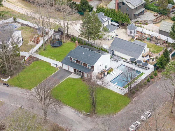 an aerial view of a house with a garden and trees