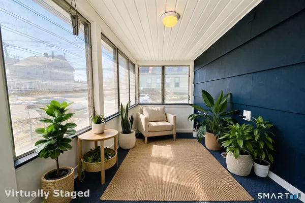 a living room with furniture and a potted plant