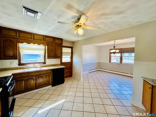 a large kitchen with a stove a sink dishwasher and a refrigerator