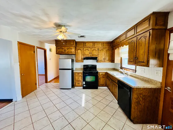 a kitchen with stainless steel appliances granite countertop a sink and cabinets