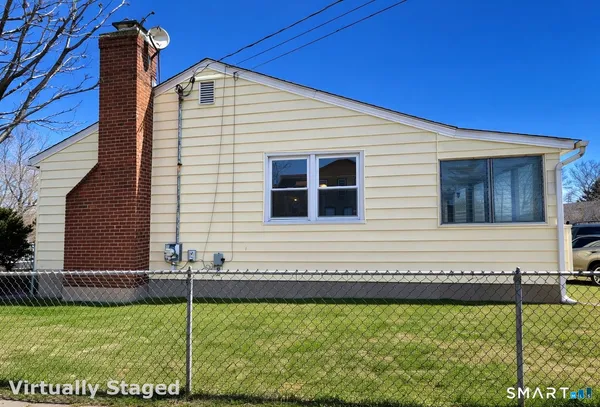 a view of a house with a backyard