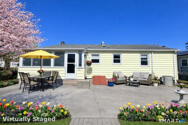 a view of a patio with table and chairs potted plants
