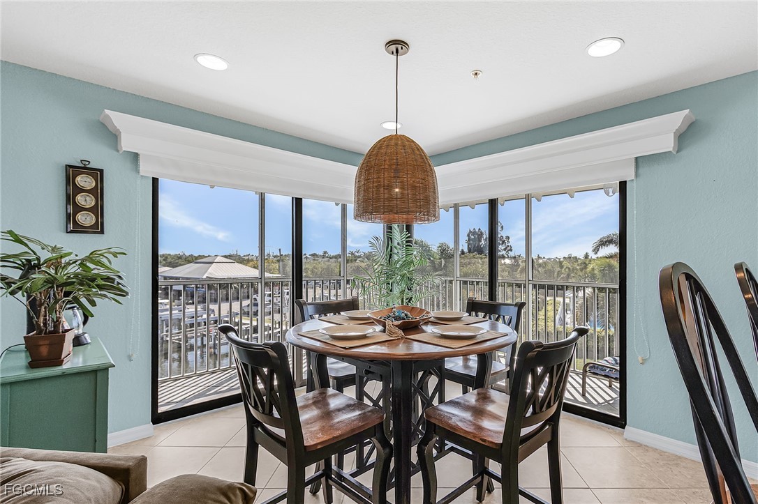 16641 Stringfellow Road, Unit 506 Bokeelia, FL 33922 - Photo 6 of 43 a view of a dining room with furniture window and outside view