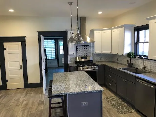 a kitchen with a stove a sink and a refrigerator