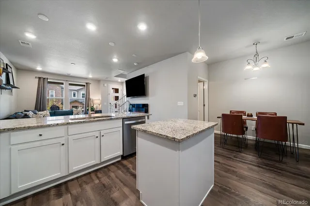 a large kitchen with kitchen island a sink a center island and stainless steel appliances