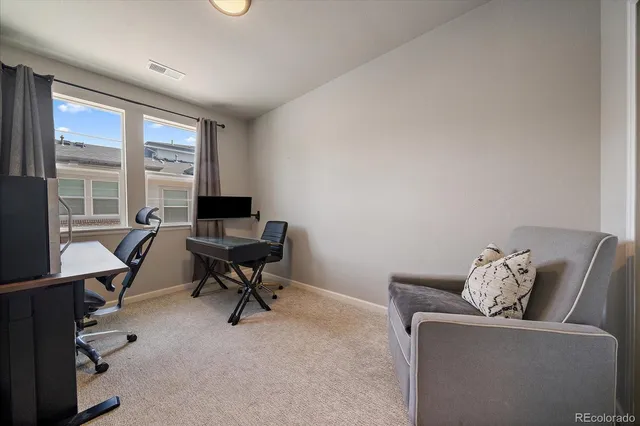 a view of a livingroom with workspace and a window