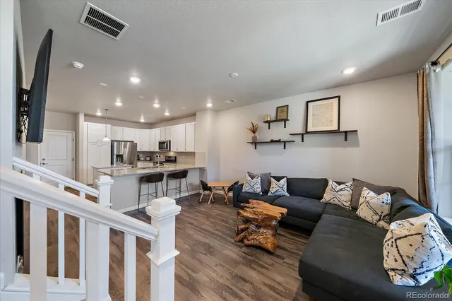 a living room with furniture and kitchen view