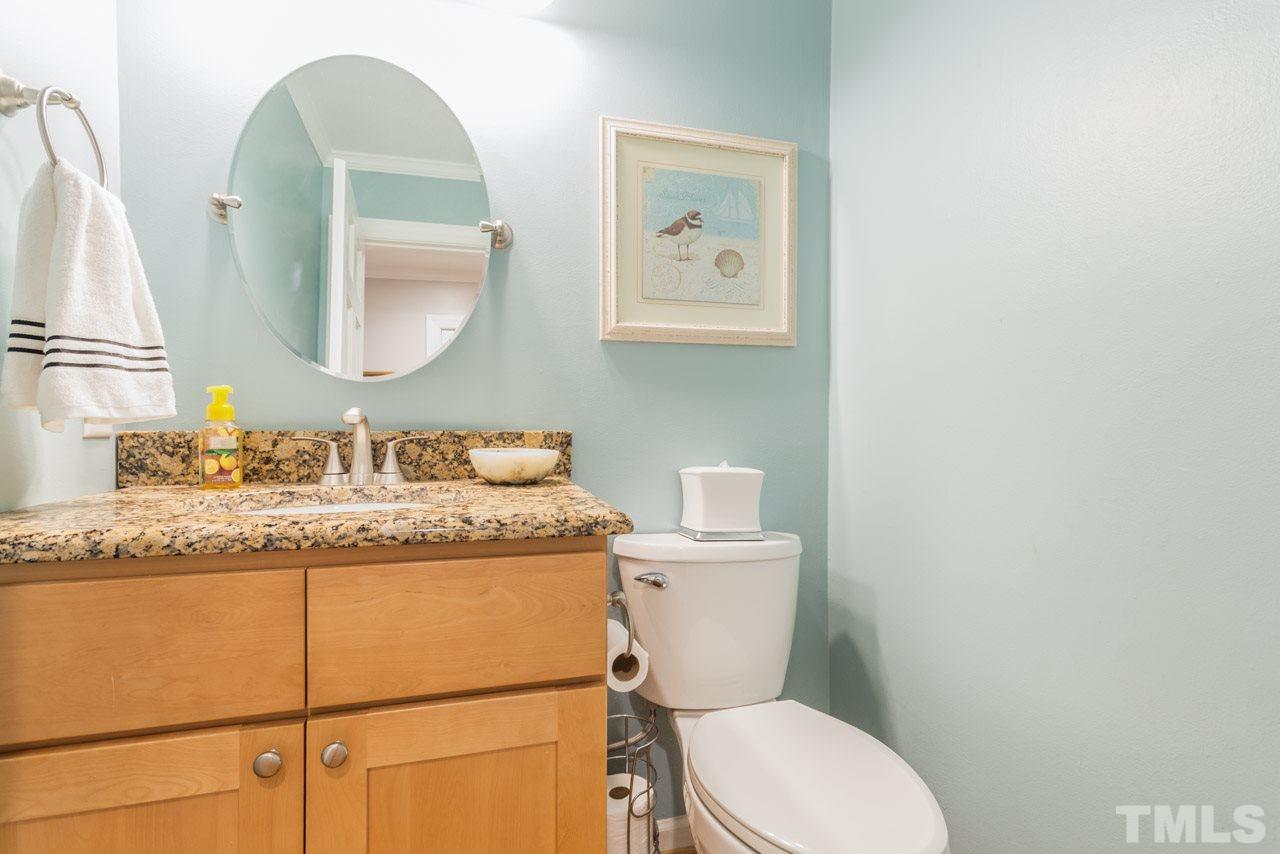 412 Amelia Avenue Raleigh, NC 27615 - Photo 13 of 25 a bathroom with a granite countertop toilet sink and mirror