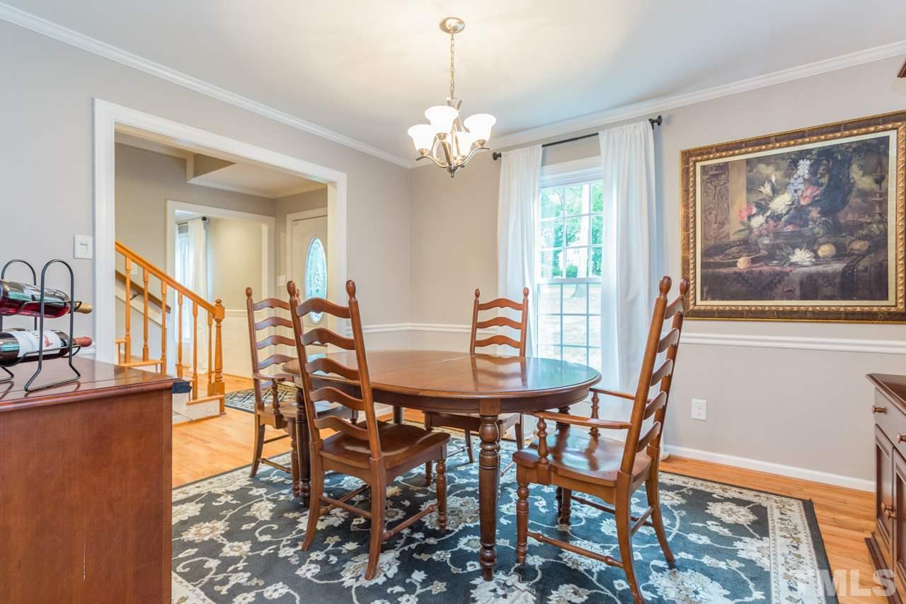 412 Amelia Avenue Raleigh, NC 27615 - Photo 14 of 25 a view of a dining room with furniture window and wooden floor