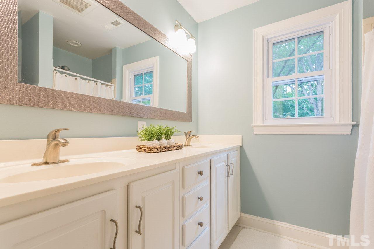 412 Amelia Avenue Raleigh, NC 27615 - Photo 16 of 25 a bathroom with a sink and a mirror