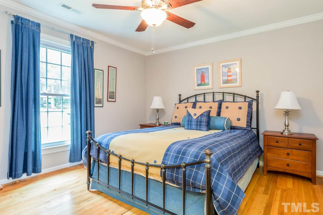 412 Amelia Avenue Raleigh, NC 27615 - Photo 17 of 25 a bedroom with a bed and wooden floor