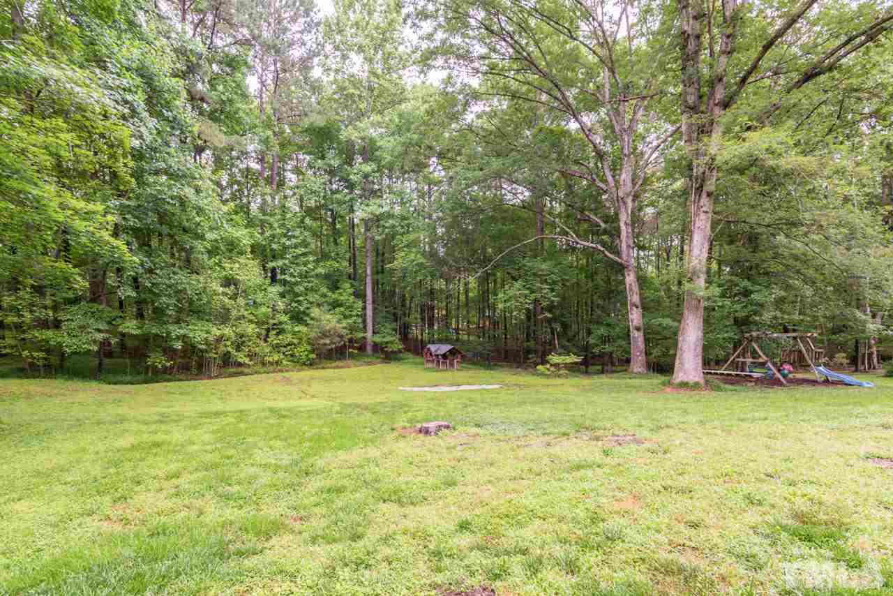 412 Amelia Avenue Raleigh, NC 27615 - Photo 25 of 25 a view of a field with trees in the background