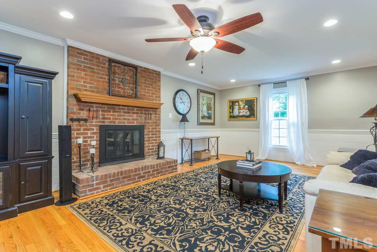 412 Amelia Avenue Raleigh, NC 27615 - Photo 4 of 25 a living room with furniture and a fireplace