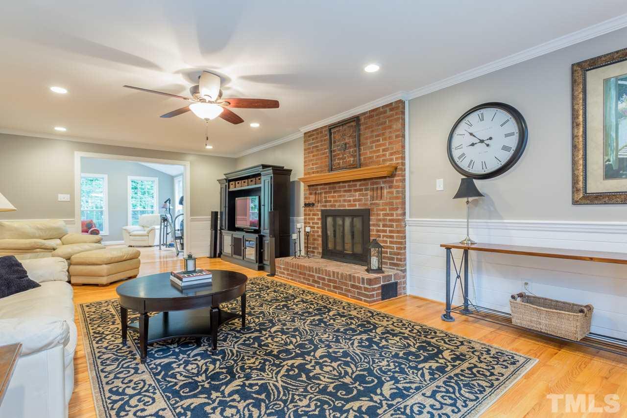 412 Amelia Avenue Raleigh, NC 27615 - Photo 6 of 25 a living room with furniture a rug and a fireplace