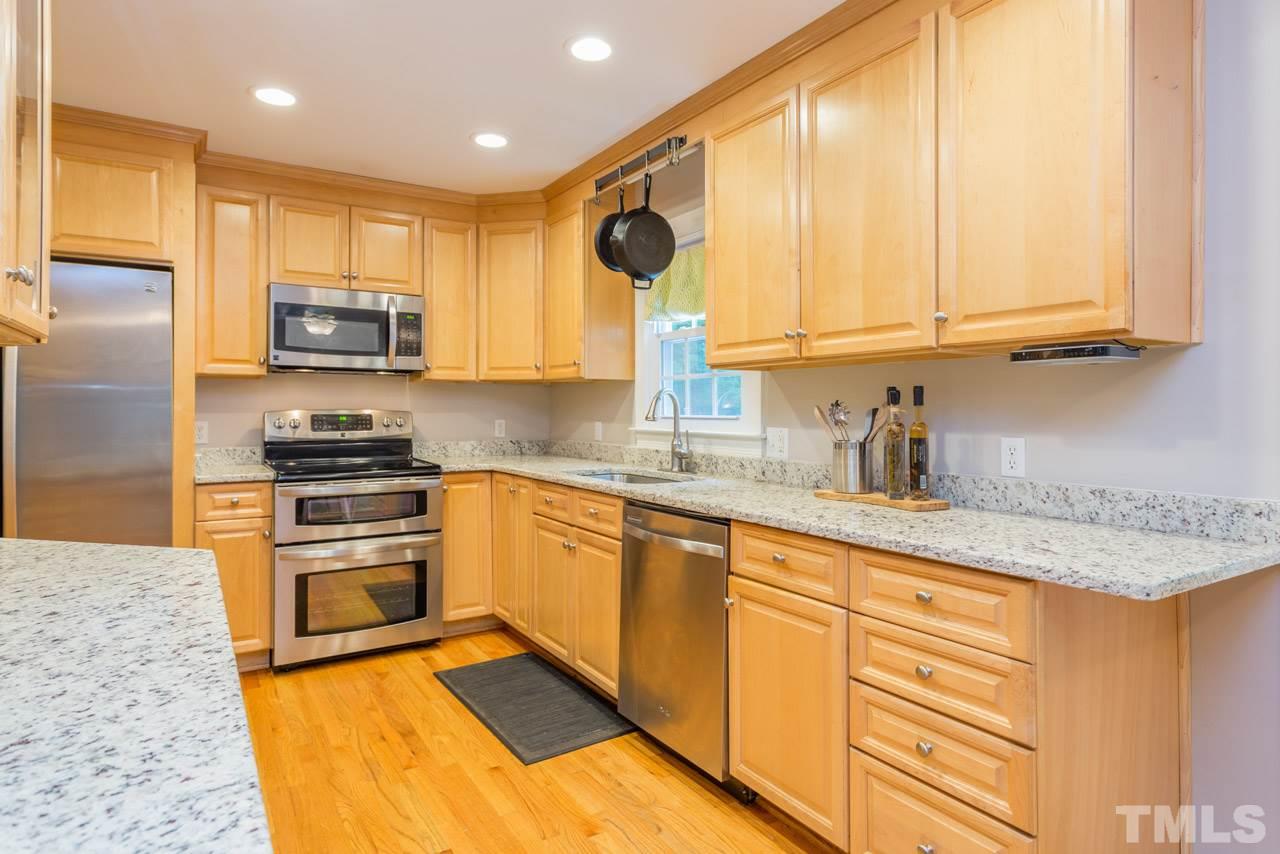 412 Amelia Avenue Raleigh, NC 27615 - Photo 7 of 25 a kitchen with granite countertop a sink stainless steel appliances and cabinets