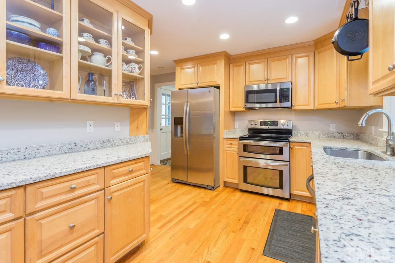 412 Amelia Avenue Raleigh, NC 27615 - Photo 8 of 25 a kitchen with stainless steel appliances granite countertop a stove a sink and a refrigerator