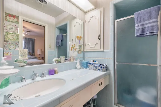 a bathroom with a granite countertop sink mirror and double