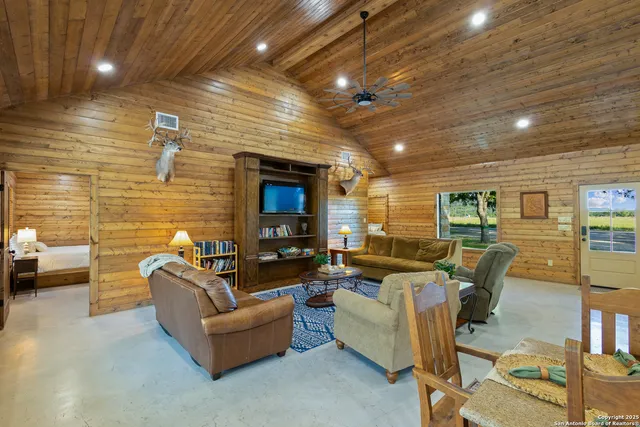 a living room with fireplace furniture and a flat screen tv